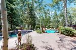 On-site amenities, include a shared outdoor heated pool, a hot tub